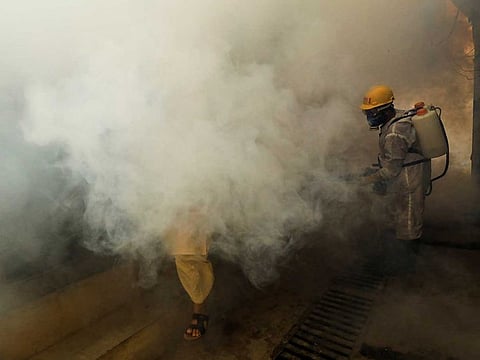 A worker sprays fumigation vapour to stem the spread of the Dengue virus in Peshawar, Pakistan, October 14, 2021. 