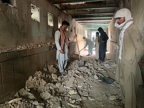 People inspect inside the mosque following a suicide bombers attack in the city of Kandahar, on Friday, October 15, 2021.  
