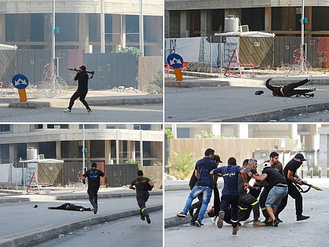 A man who is shot and rescued after trying to fire a rocket-propelled grenade, during a gunfire in Beirut on October 14, 2021. 