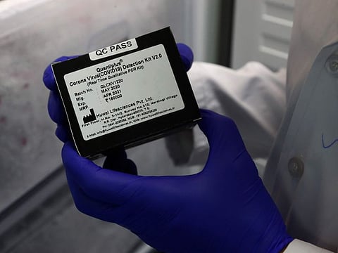 A scientist at Huwel Lifesciences displays RT-PCR test kit manufactured by them in Narsingi, Hyderabad, India, on October 7, 2021. 