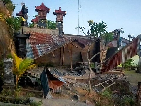 This handout picture taken and released on October 16, 2021 by the Bali regional disaster management agency (BPBD) shows collapsed houses after a 4.8 earthquake occurred in Karangasem, on the tourist island of Bali. 
