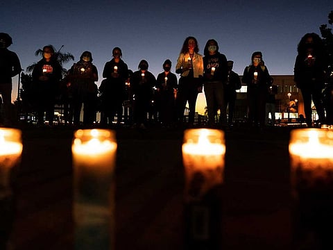 People hold candles, meant to represent Haitian migrants deported from the United States to Haiti, during a vigil Thursday, Oct. 14, 2021, in San Diego. A group of 17 US missionaries including children was reportedly kidnapped by a gang in Haiti on Saturday. 