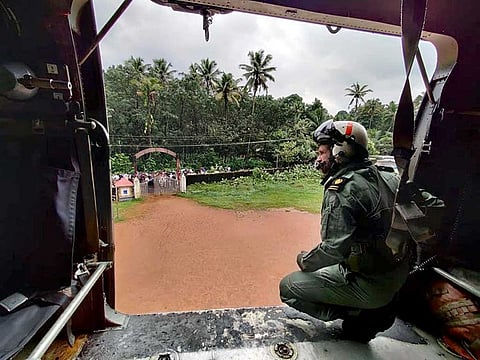 Kochi Southern Naval Command (SNC) personnel inside a chopper on the way to provide relief material to landslide affected areas, at Koottickal, in Kottayam on Sunday, October 17, 2021.  