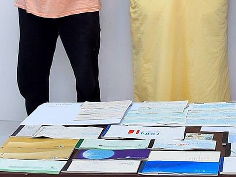 Police found cheque books, company stamps and a counterfeit cash detector in the suspects' possession 