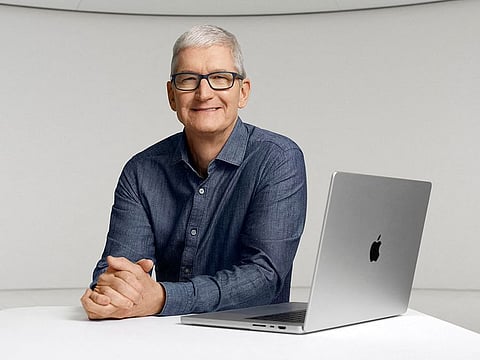 Apple CEO Tim Cook poses with a new MacBook Pro during an online event unveiling new products at Apple Park in Cupertino, California.