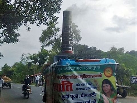 The candidate on poll campaign with real 'chimney' symbol.