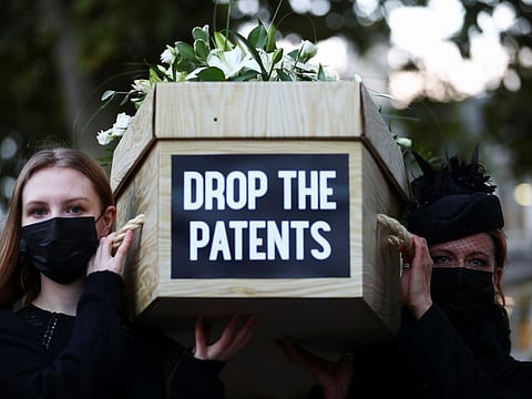Members of Global Justice Now protest with coffins to highlight the global number of deaths from COVID-19, at Parliament Square, in London, on October 12, 2021. 