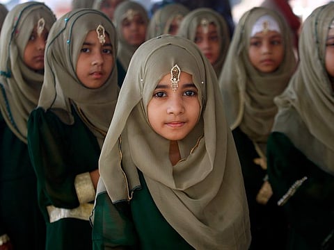 Girls participate in a celebration on birthday of the Prophet Mahammad (PBUH), in Karachi, on October 19, 2021. 