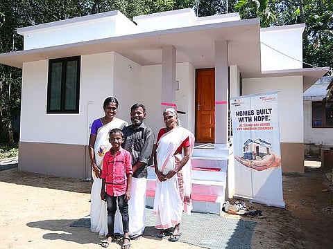 AK Radhakrishnan, an unskilled labourer with his mother, wife and school-going son at their new house in Puthenvelikkara.