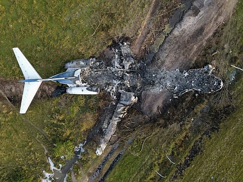 The remnants of an aircraft, which caught fire soon after a failed take-off attempt at Houston Executive Airport, are seen just north of Morton Road in Brookshire on October 19, 2021. 