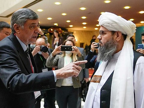 Russian presidential envoy to Afghanistan Zamir Kabulov speaks with a representative of the Taliban delegation Mawlawi Shahabuddin Dilawar before the beginning of international talks on Afghanistan in Moscow, Russia, October 20, 2021. 
