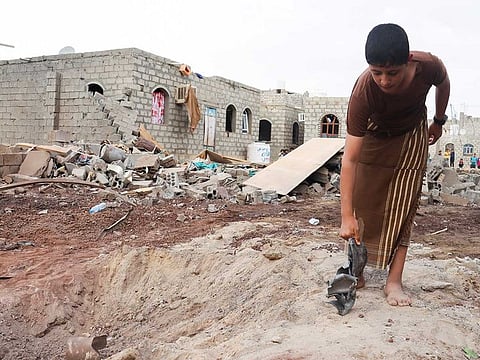 File picture: A boy holds shrapnel of a missile at the site of a Houthi missile attack in Marib, Yemen October 3, 2021. 