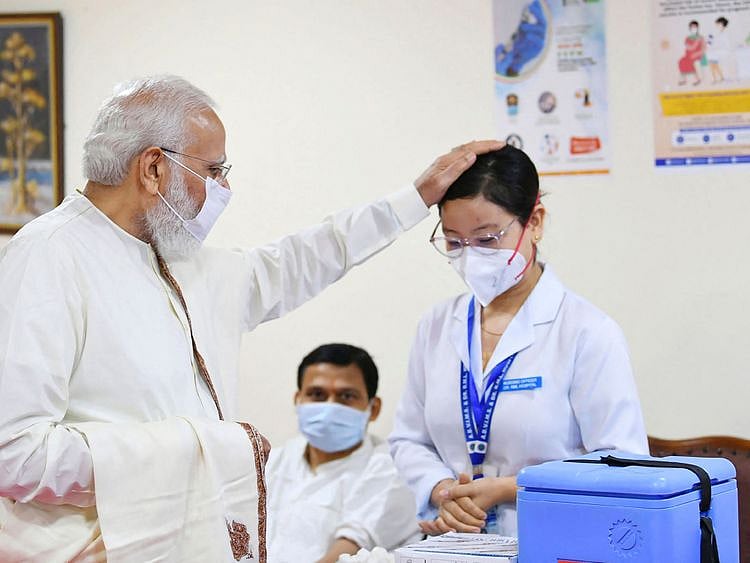  India's Prime Minister Narendra Modi greeting a health worker during his visit to a vaccination centre at Ram Manohar Lohia Hospital in New Delhi as India administered its one billionth COVID-19 vaccine dose on October 21.
