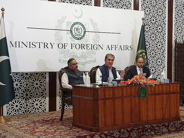 Pakistani Foreign Minister Shah Mahmood Qureshi (centre) along with Foreign Secretary Sohail Mahmood and Foreign Office spokesperson Asim Iftikhar, speaks during a news conference in Islamabad on October 21, 2021.