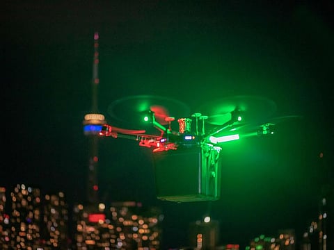 Unither Bioelectronique's drone transporting a pair of donor lungs, high above Toronto traffic at night.  A