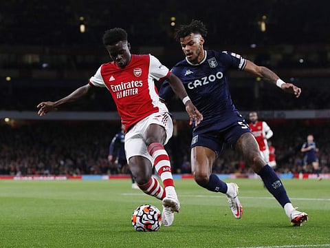 Arsenal's Bukayo Saka in action with Aston Villa's Tyrone Mings.