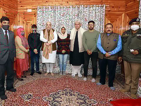 India's Home Minister Amit Shah with family members of slain Inspector Parvez Ahmed, Jammu and Kashmir Lieutenant Governor Manoj Sinha, Minister of State for the Ministry of Science and Technology Jitendra Singh, and Jammu and Kashmir Director General of Police Dilbag Singh, at Nowgam, in Anantnag on Saturday. 