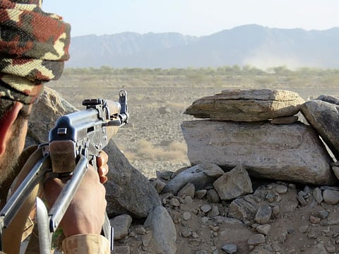 A fighter loyal to Yemen's Saudi-backed government mans a position at the frontline facing Iran-backed Al Houthi militants in the country's northeastern province of Marib, on October 23, 2021. 