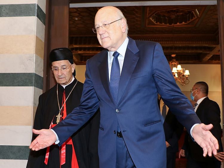 Lebanese Prime Minister Najib Mikati gestures meets with Maronite Patriarch Bechara Boutros Al Rai at the government palace in Beirut on October 26, 2021. Mikati, in a phone call with Kordahi on Friday evening, asked him to put the national interest first and “take the right decision to fix Arab relations with Lebanon,” a statement by his office said.