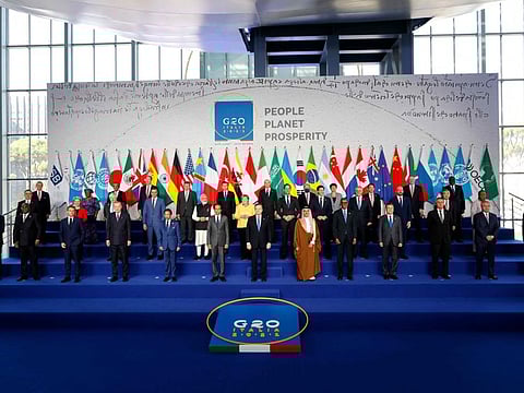 Italian Prime Minister Mario Draghi (cemtre-front) stands with world leaders as they gather for the official family photograph on day one of the G20 Summit at the convention centre of La Nuvola, in the EUR district of Rome on October 30, 2021. 