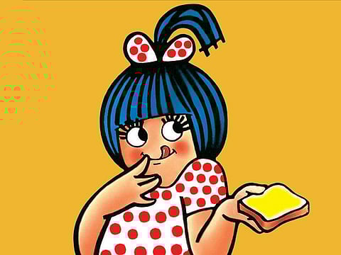 The Amul girl is the famous mascot dressed in a polka dotted frock with blue hair and a half pony tail