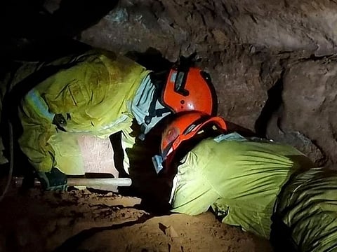 Firefighters working to rescue civilian firefighters buried in a cave after a collapse in Altinopolis, Sao Paulo state, Brazil. 