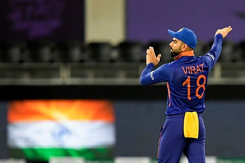 India's captain Virat Kohli adjusts the field during the ICC mens Twenty20 World Cup cricket match against New Zealand at the Dubai International Cricket Stadium in Dubai, UAE.