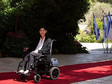 Israel Energy Minister Karine Elharrar arrives for a group portrait with incoming Prime Minister Naftali Bennett, outgoing President Reuvin Rivlin, and her fellow cabinet ministers in the new government, on June 14, 2021 photo in Jerusalem. She arrived on Tuesday, November 2, 2021 to the global climate summit in Scotland, a day after police prevented her wheelchair accessible vehicle from reaching the conference’s venue. 