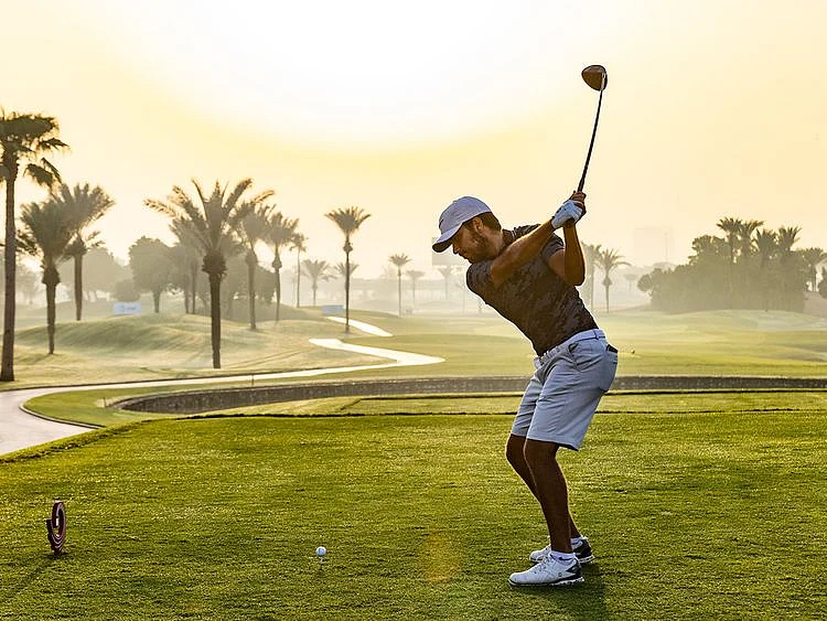 Ahmad Skaik hits the opening tee shot at the AAC