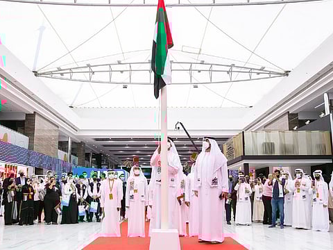 The UAE flag being raised at Sharjah International Book Fair in Expo Centre Sharjah on Tuesday. 