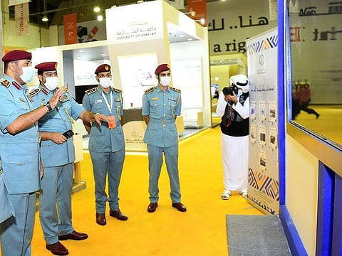 Sharjah Police officials view a screen launching the ‘Security Digital Library’ at SIBF 2021 at Expo Centre Sharjah on Thursday