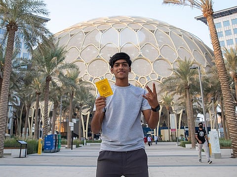 Fazil Ummer with his Expo passport that has stamps from visiting all Expo country pavilions in three days