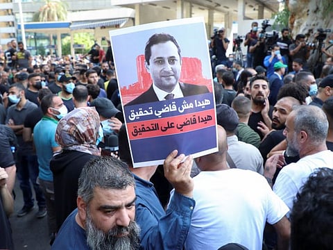 Supporters of Lebanese militant group Hezbollah, and Amal and the Christian Marada movement take part in a protest against Tarek Bitar, the lead judge of the port blast investigation, near the Justice Palace in Beirut, on October 14, 2021. 