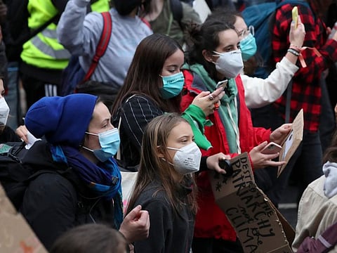 Climate activist Greta Thunberg, centre, marches with other activists through the streets of Glasgow, on November 5, 2021 which is the host city of the COP26 UN Climate Summit. The protest was taking place as leaders and activists from around the world were gathering in Scotland's biggest city for the UN climate summit, to lay out their vision for addressing the common challenge of global warming. 