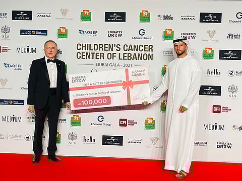 Mohammad Alawadhi, managing partner of Emirates Draw, presenting the cheque to Dr Cesar Bassim, chairman of CCCL. 