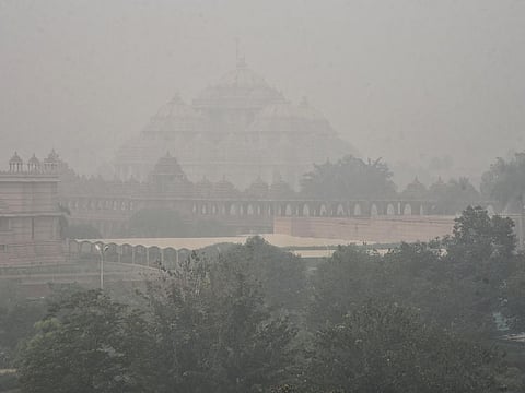 Dense smog engulfs the Akshardham temple as air quality index (AQI) readers hit maximum 999 after Diwali, in New Delhi on Friday. 