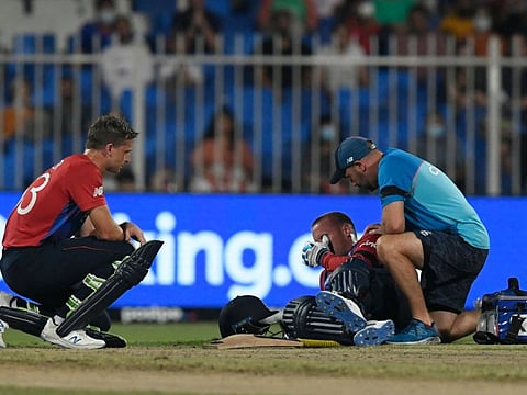 England's Jason Roy (centre) reacts as he lies on the pitch with an injury during the ICC mens Twenty20 World Cup cricket against South Africa at the Sharjah Cricket Stadium in Sharjah.