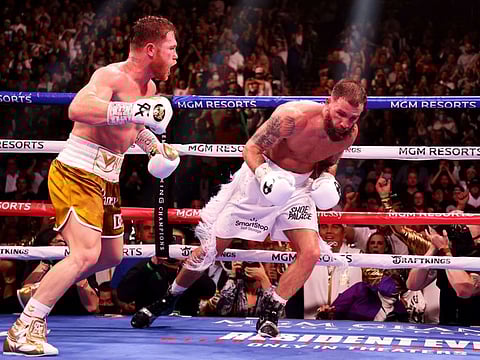 Canelo Alvarez (left) punches Caleb Plant against the ropes during their championship bout for Alvarez's WBC, WBO and WBA super middleweight titles and Plant's IBF super middleweight title at MGM Grand Garden Arena in Las Vegas, Nevada.