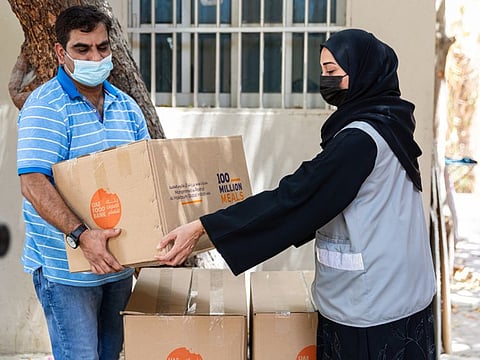 A beneficiary in UAE receives a food parcel under UAE's '100 Million Meals' campaign