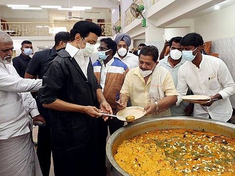 Tamil Nadu Chief Minister MK Stalin distributes meals to the people affected by the heavy rains, at the Sembiam Merchants Association Wedding Hall, Kolathur, in Chennai on Tuesday. 