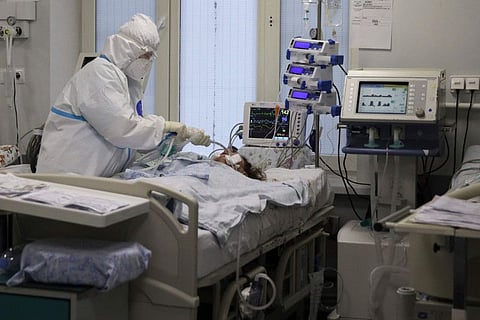 A medical staffer treats a COVID-19 patient at an ICU at the Regional Clinical Hospital 1, in Krasnodar, south Russia, on November 2, 2021.  
