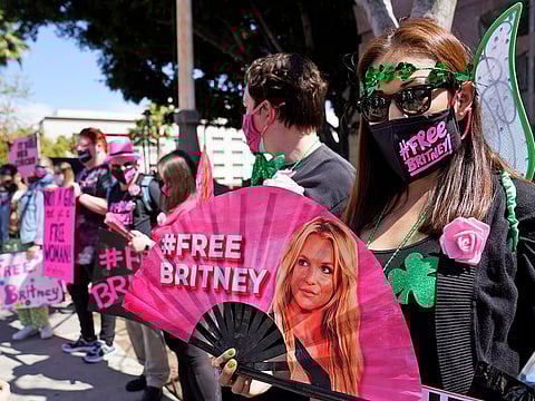 Britney Spears supporter Kiki Norberto holds a hand fan outside a court hearing concerning the pop singer's conservatorship at the Stanley Mosk Courthouse on March 17, 2021, in Los Angeles.