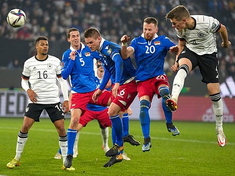 Germany's Matthias Ginter (right) heads the ball at goal during the World Cup 2022 group J qualifying soccer match against Liechtenstein in Wolfsburg, Germany.