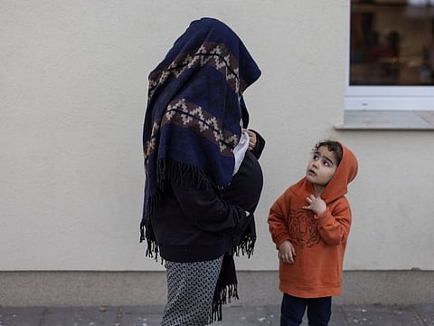 Iraqi migrant Umm Malak, 26 years old and nine months pregnant, with her daughter at a refugee centre in Bialystok, Poland, on November 12, 2021. 