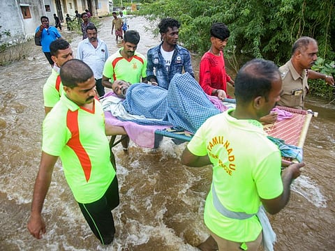 Rescuers evacuate people from a flooded area in Kanyakumari in Tamil Nadu, a neighbouring state of Kerala, which was badly affected by heavy rains, on November 12, 2021. 