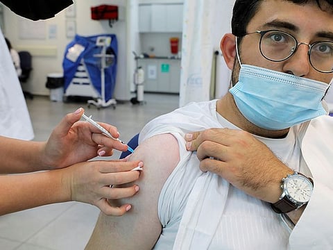 An Israeli man receives his third dose of the coronavirus disease (COVID-19) vaccine, in Beit Shemesh, Israel October 14, 2021. 