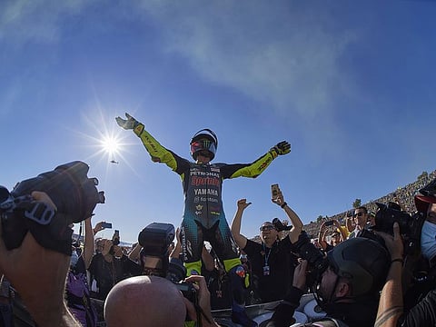 Valentino Rossi reacts after competing in his last ever race in MotoGP