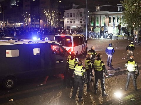 Dutch riot police deploy at Zaailand square to remove a large group of people who, among other things, threw fireworks in Leeuwarden on November 13, 2021 as the cabinet tightened the coronavirus measures again due to rising contamination figures.