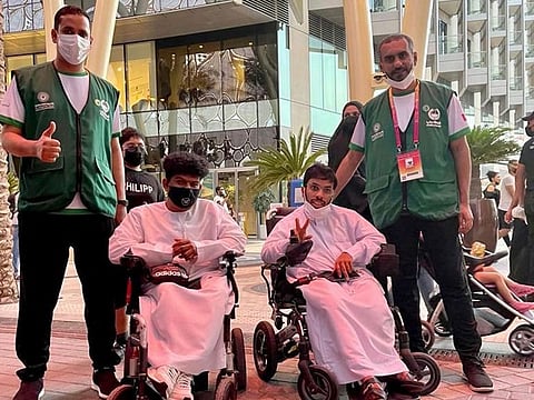 Mohammad Jamal Al Nahdi and Hazaa Mohammed Ahmed from Dubai Police with two special visitors at Expo 2020 Dubai.