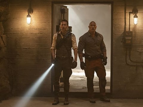 Red Notice. (L to R) Ryan Reynolds as Nolan Booth and Dwayne Johnson as John Hartley in Red Notice.